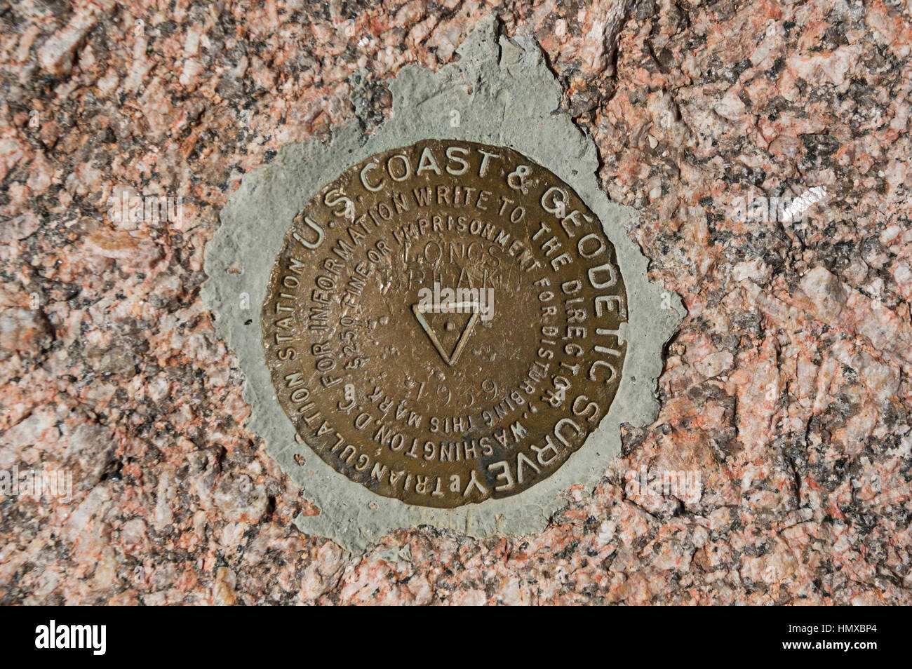 the triangulation point survey marker on the summit of Longs Peak in Rocky Mountain National Park Stock Photo