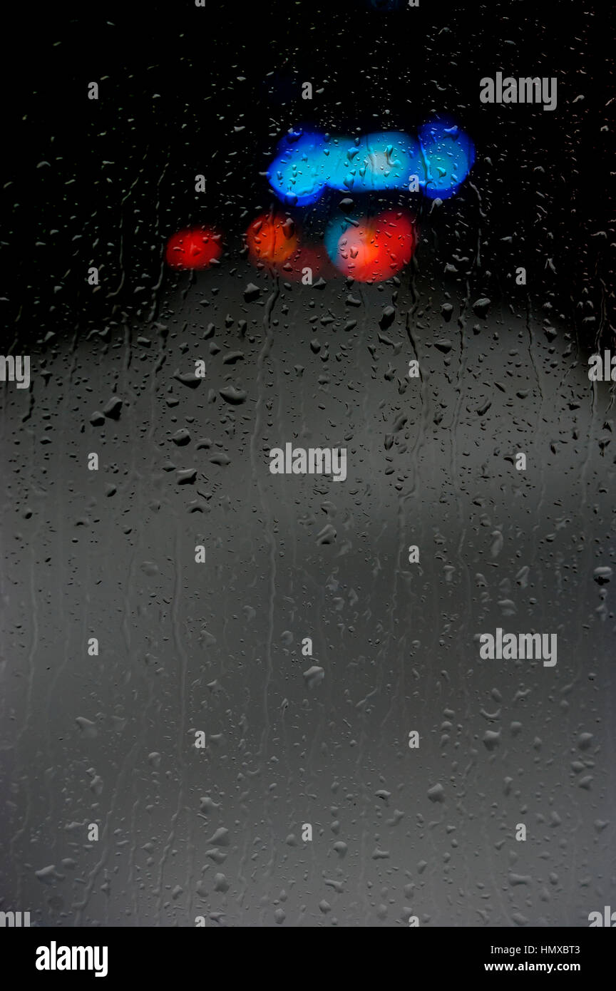 Looking through rainy window at abstract car lights Stock Photo - Alamy