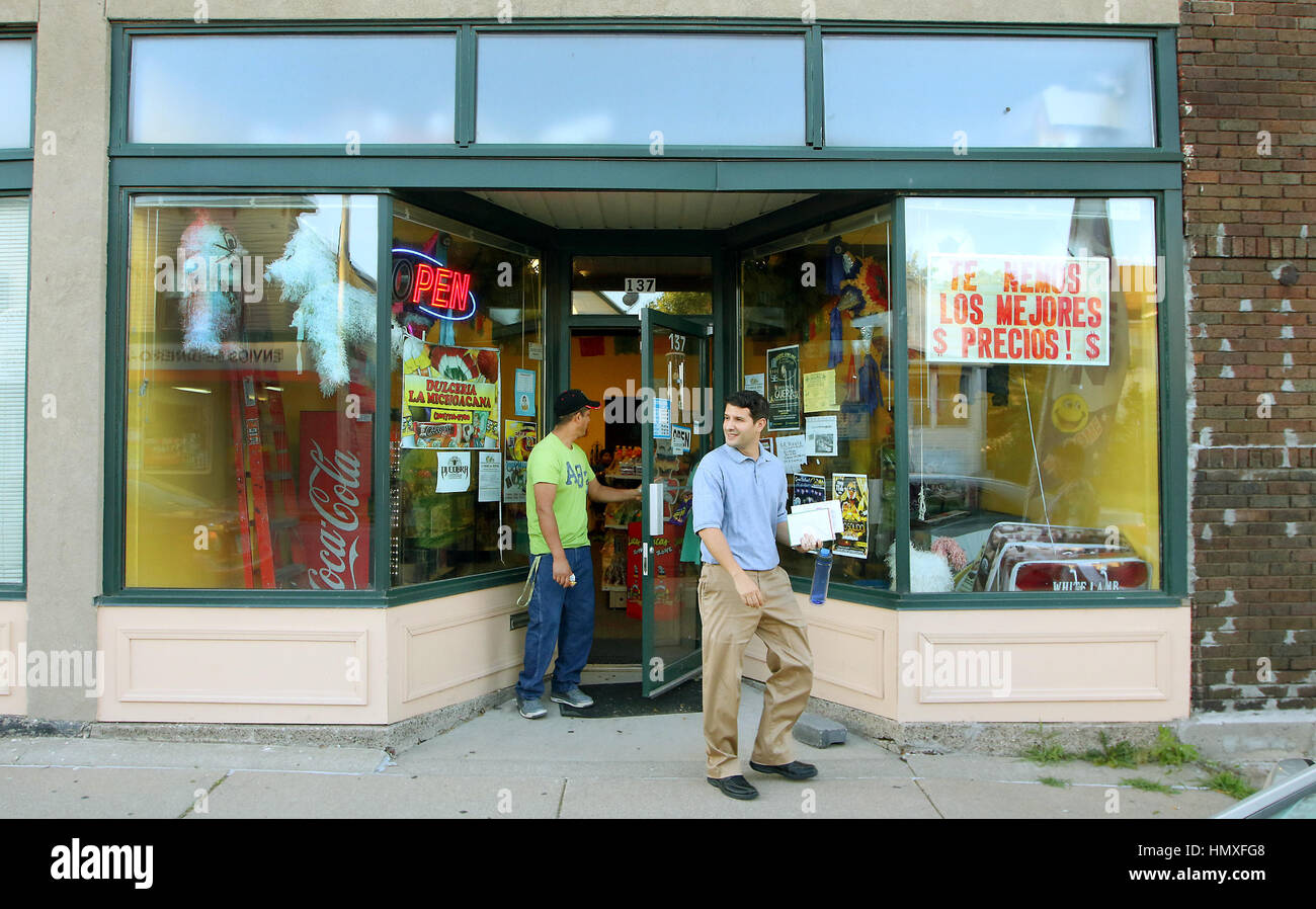 June 6, 2016 - Iowa, U.S. - Luis Lopez store owner, left and Luis Pereira of Global Communities leave the Dulceria La Michoacana candy store owned by Pereira located on 4th Avenue in the Floreciente neighborhood. (Credit Image: © Quad-City Times via ZUMA Wire) Stock Photo