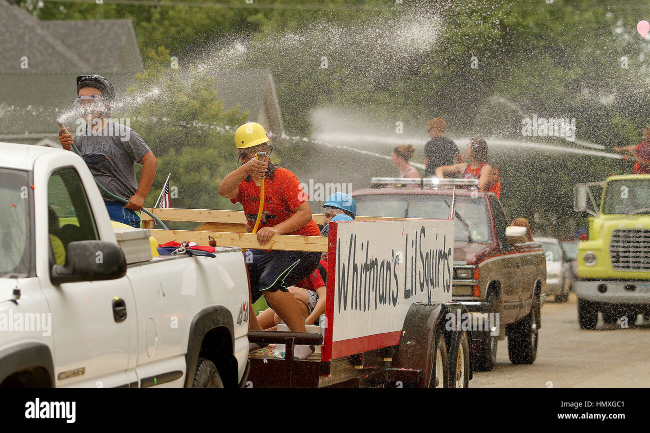 Grand Mound, Iowa, USA. 4th July, 2016. Kids wearing helmets and goggles spray water on parade watchers as they try and avoid being hit by water balloons, Monday, July 4, 2016, during the 4th of July Parade in Grand Mound, IA. Credit: John Schultz/Quad-City Times/ZUMA Wire/Alamy Live News Stock Photo