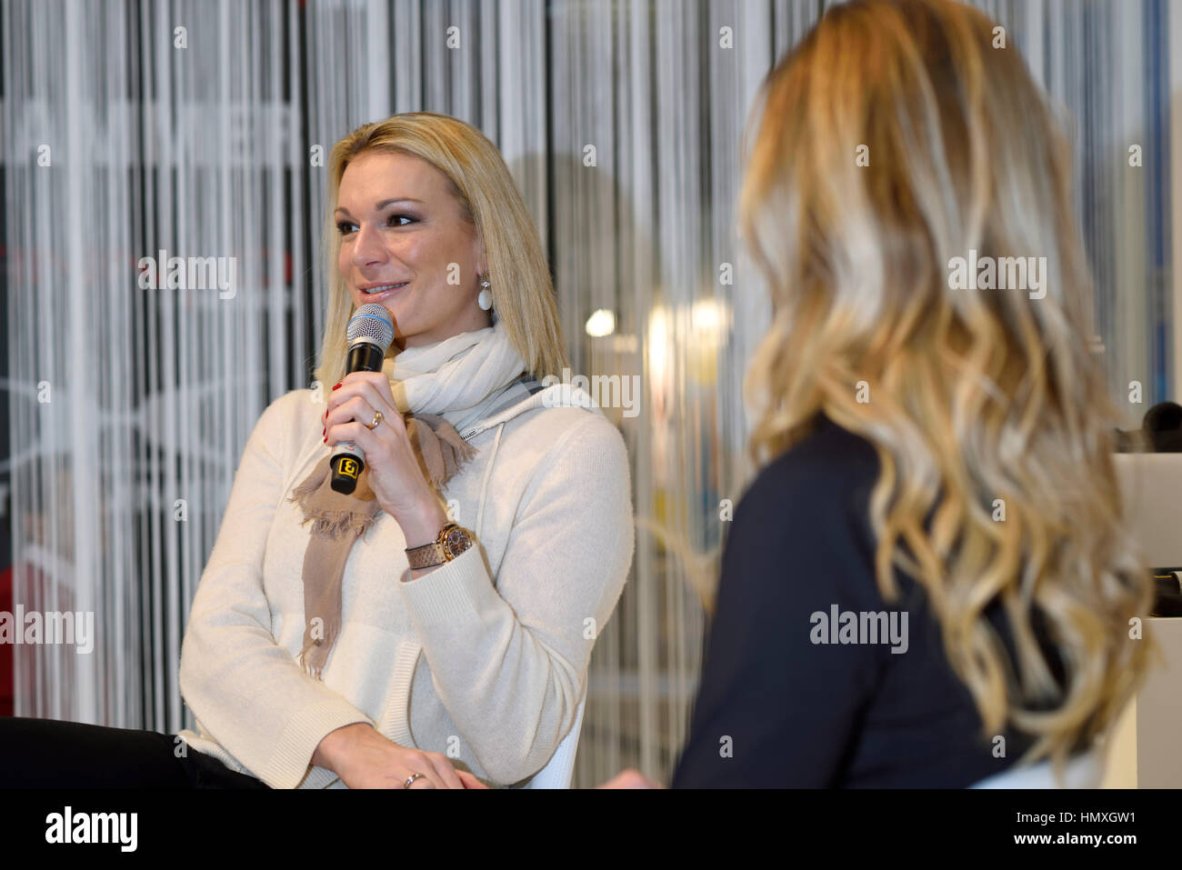 Munich, Germany. 6th February, 2017. Maria Höfl-Riesch (left side), former German alpine ski racer and Olympic gold medalist, presents her new fitness book 'Maria macht dich fit/Maria makes you fit' at the ISPO winter sports tradefair in Munich, Germany. Stock Photo
