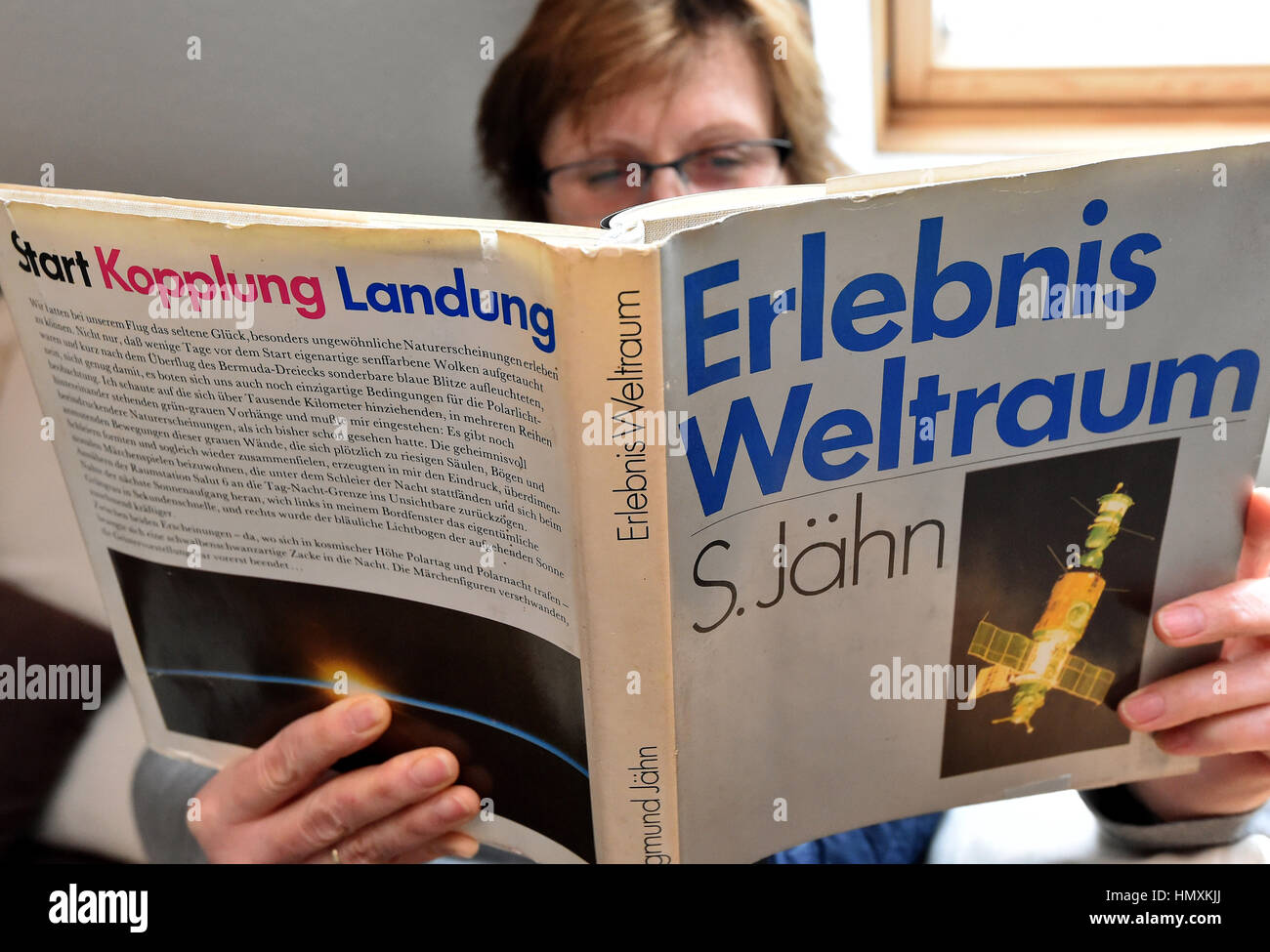 Berlin, Germany. 6th Feb, 2017. ILLUSTRATION - A woman reads the first edition of the book 'Erlebnis Weltraum' (lit. 'Experience of Space') from Sigmund Jaehn in Berlin, Germany, 6 February 2017. It was published by Militaer publishing in the GDR in 1983. Credit: dpa/Alamy Live News Stock Photo