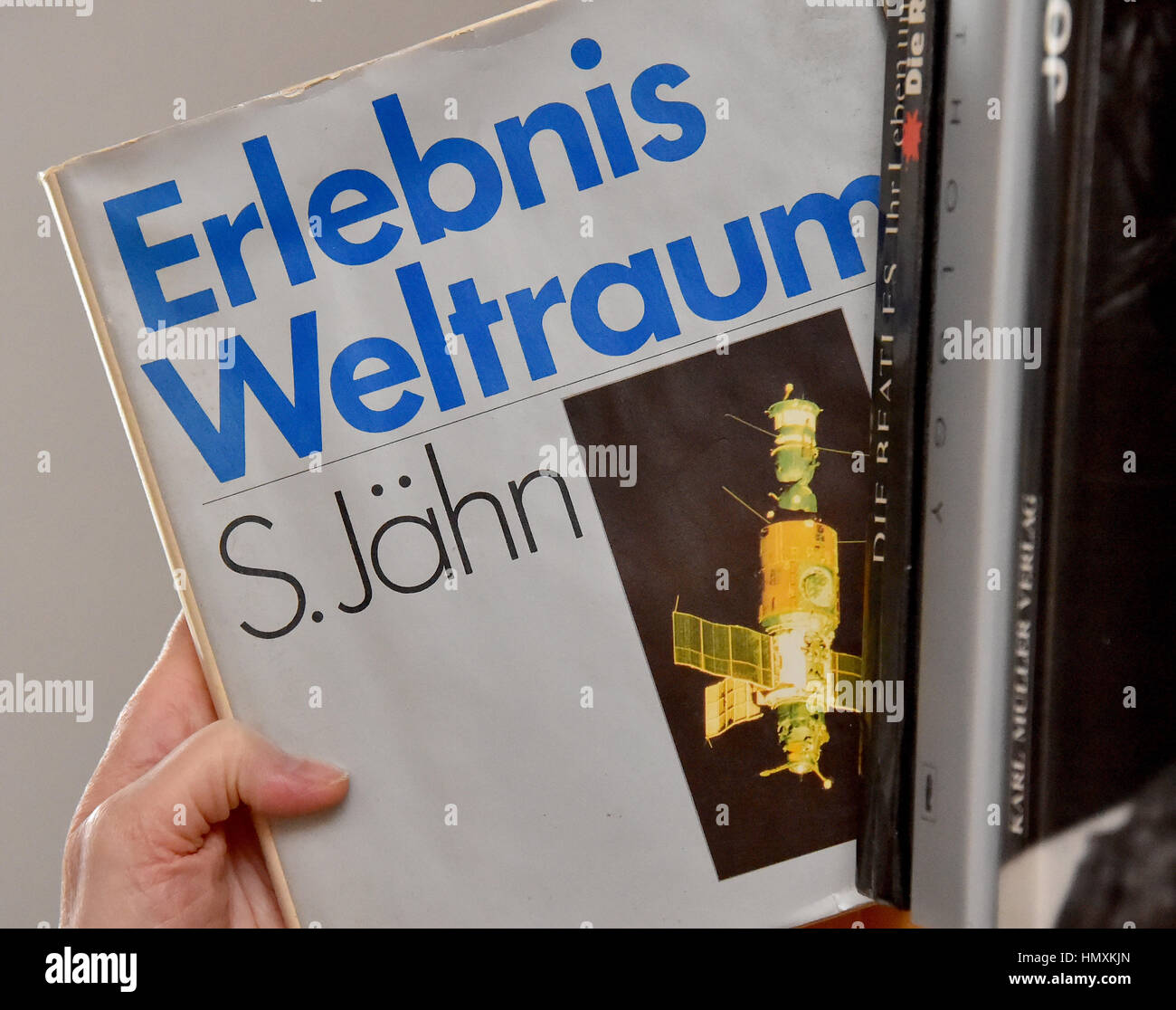 Berlin, Germany. 6th Feb, 2017. ILLUSTRATION - A woman reads the first edition of the book 'Erlebnis Weltraum' (lit. 'Experience of Space') from Sigmund Jaehn in Berlin, Germany, 6 February 2017. It was published by Militaer publishing in the GDR in 1983. Photo: Bernd Settnik/dpa-Zentralbild/dpa/Alamy Live News Stock Photo