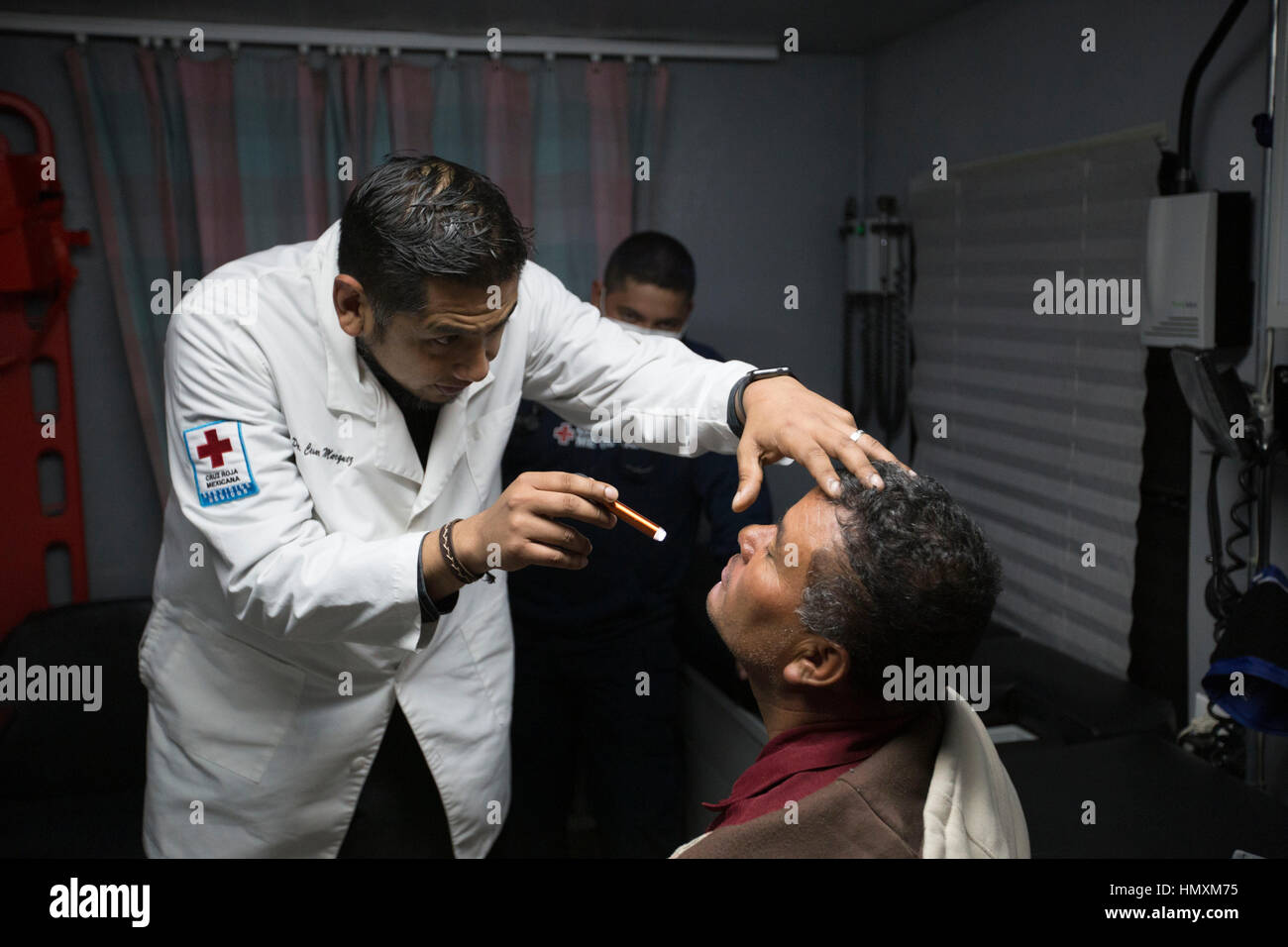 Tijuana, Mexico. 6th Feb, 2017. An International Red Cross doctor checks a Honduran migrant before his entrance to a shelter in Tijuana, Mexico, on Feb. 6, 2017. U.S. President Donald Trump signed two executive orders on Jan. 25 to have the Department of Homeland Security begin planning, designing and building a 'physical barrier' along the U.S.-Mexico border, identify undocumented immigrants, and remove those who have criminal records. Credit: David de la Paz/Xinhua/Alamy Live News Stock Photo