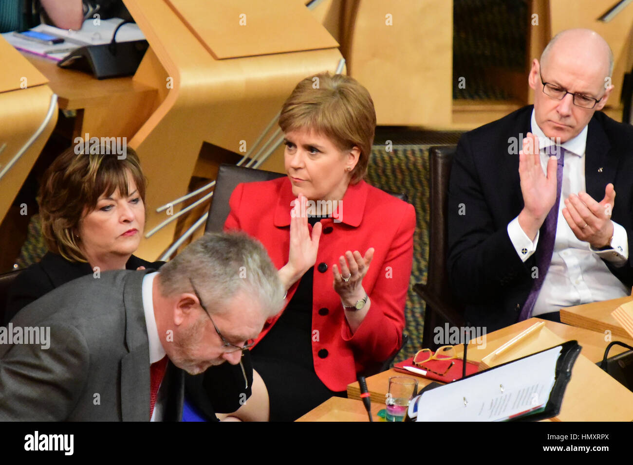 Edinburgh, UK. 7th Feb, 2017. First Minister Nicola Sturgeon applauds Scottish Brexit Minister Michael Russell (2nd L) as he sits down after introducing a Scottish Government debate in the Scottish Parliament opposing the triggering of Article 50, Credit: Ken Jack/Alamy Live News Stock Photo