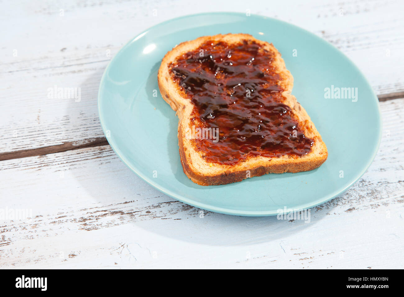 Typical Dutch apple syrup called Appelstroop on bread on wooden background Stock Photo
