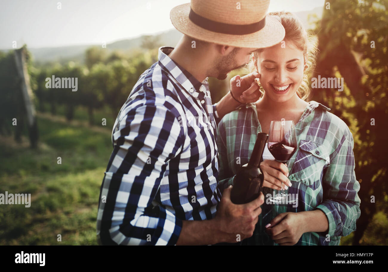 Happy people tasting wine in vineyard Stock Photo - Alamy