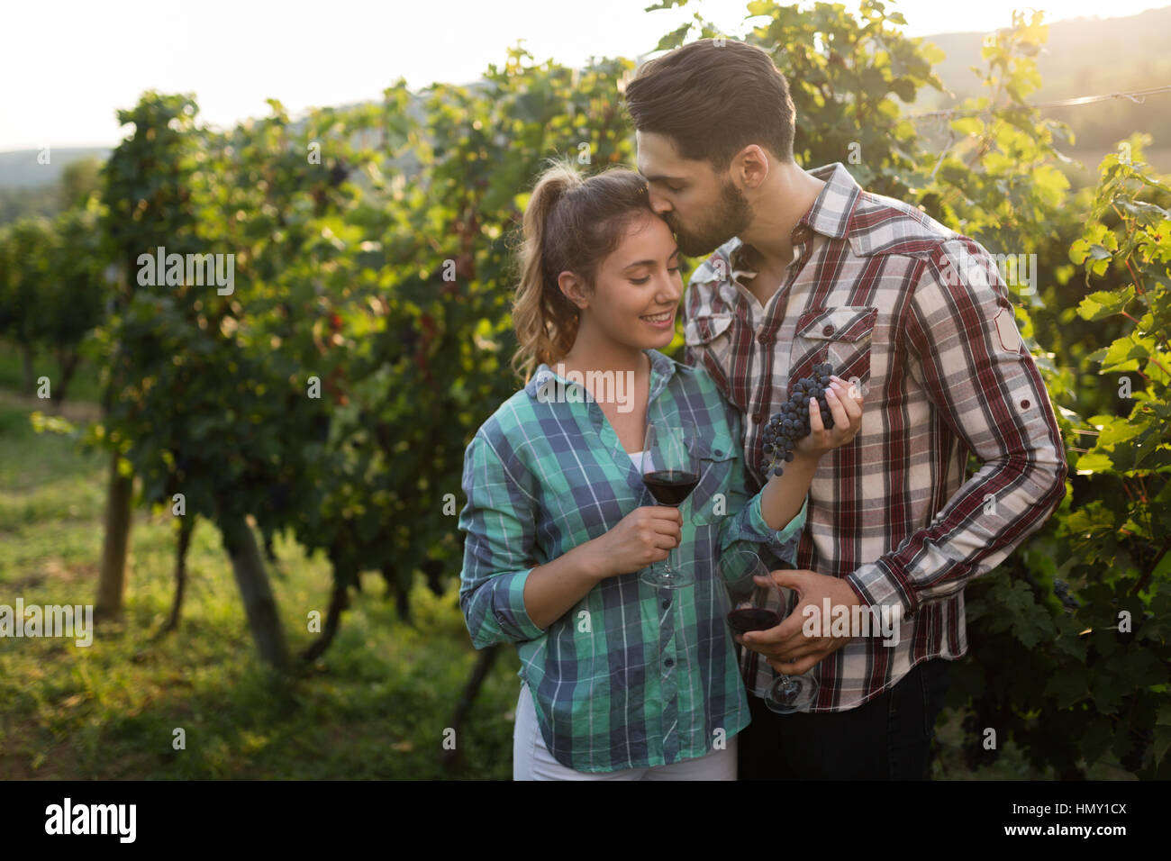 Happy people tasting wine in vineyard Stock Photo