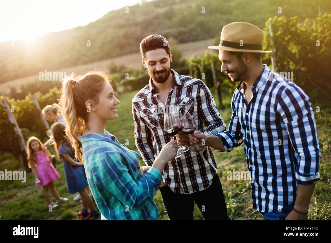 Happy people tasting wine in vineyard Stock Photo - Alamy