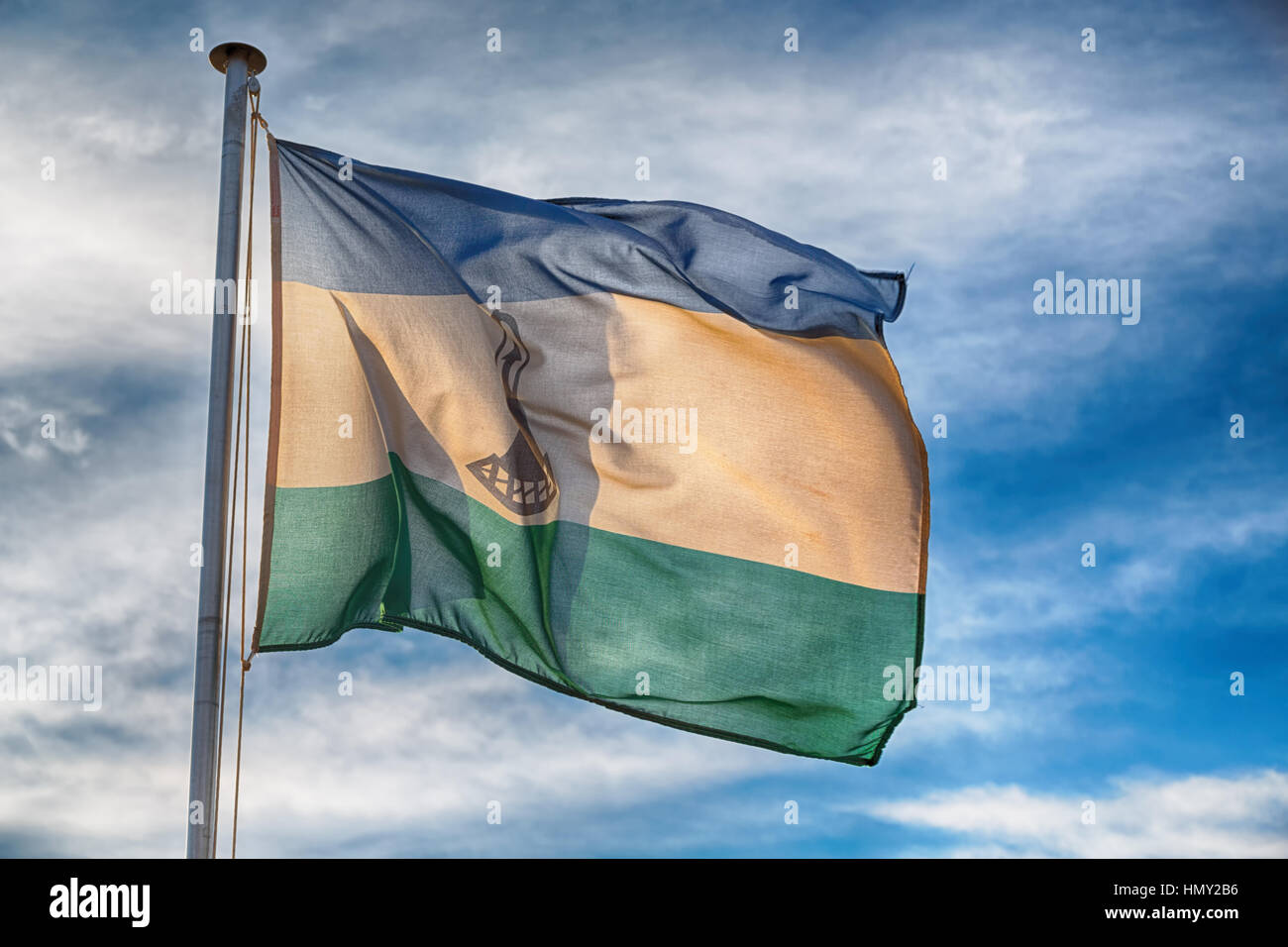 blur in lesotho waving national flag in the cloudy sky Stock Photo - Alamy