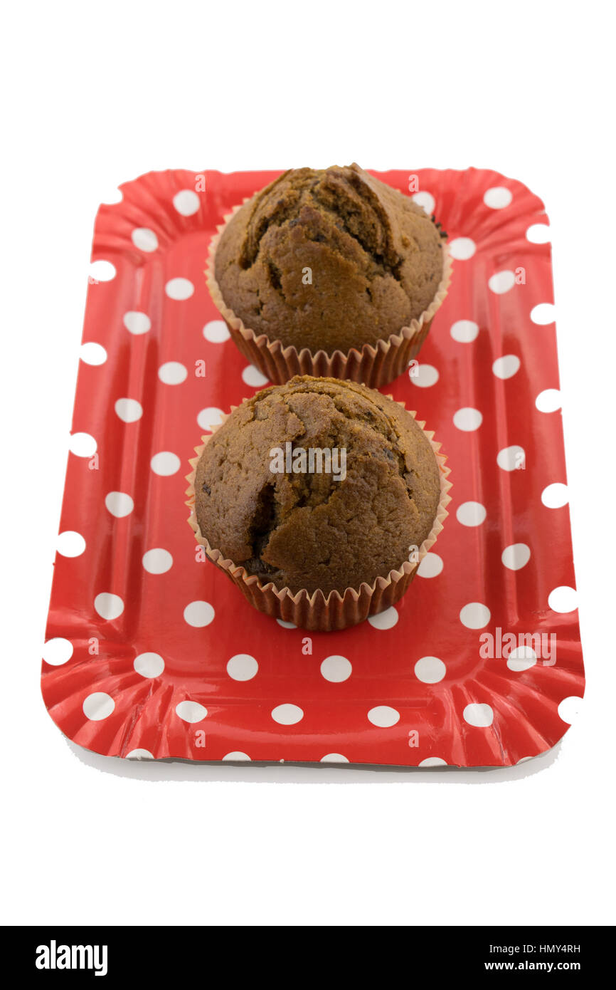 Tasty chocolate muffins on the red plate on the white background Stock Photo