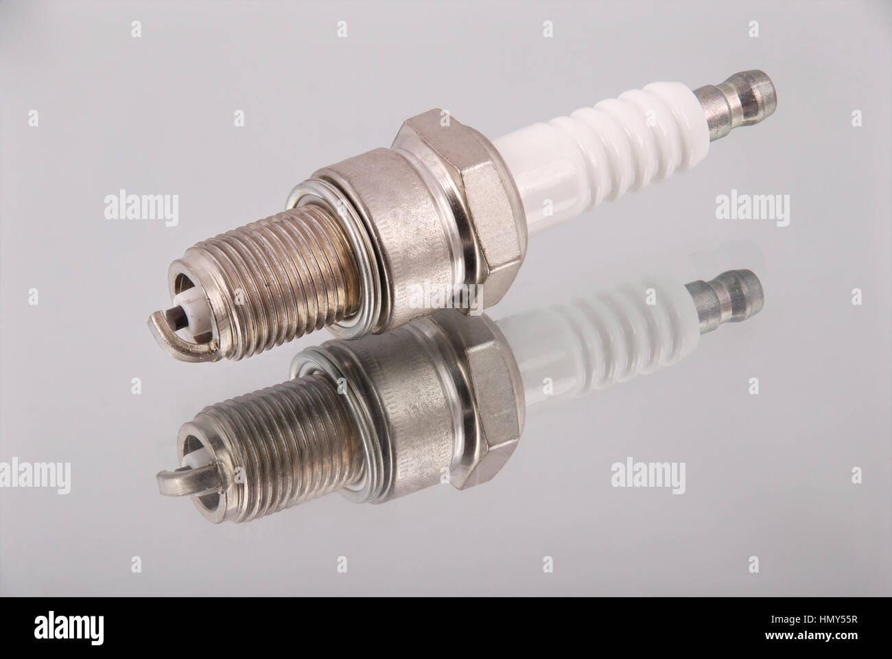 One new spark plugs on a mirror background Stock Photo