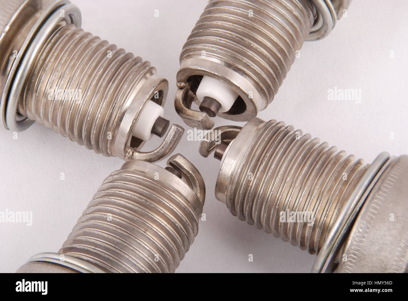 Four new spark plugs on a gray background Stock Photo