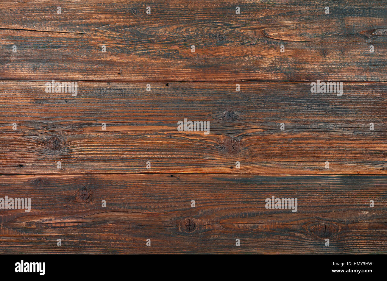 Dark brown old vintage knotty wooden wide planks wall background texture Stock Photo