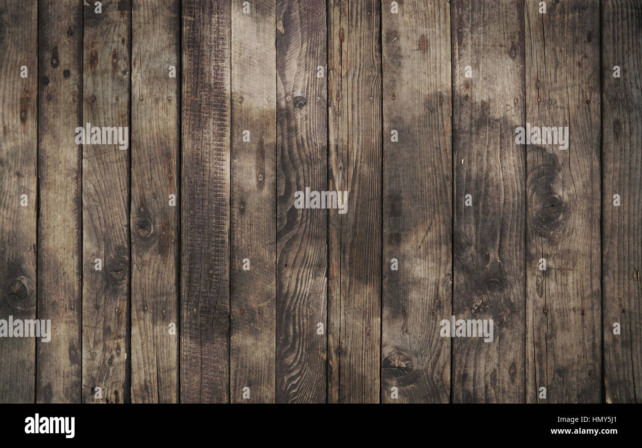 Old vintage aged grunge dark brown and gray wooden floor planks texture background with stains and nails Stock Photo