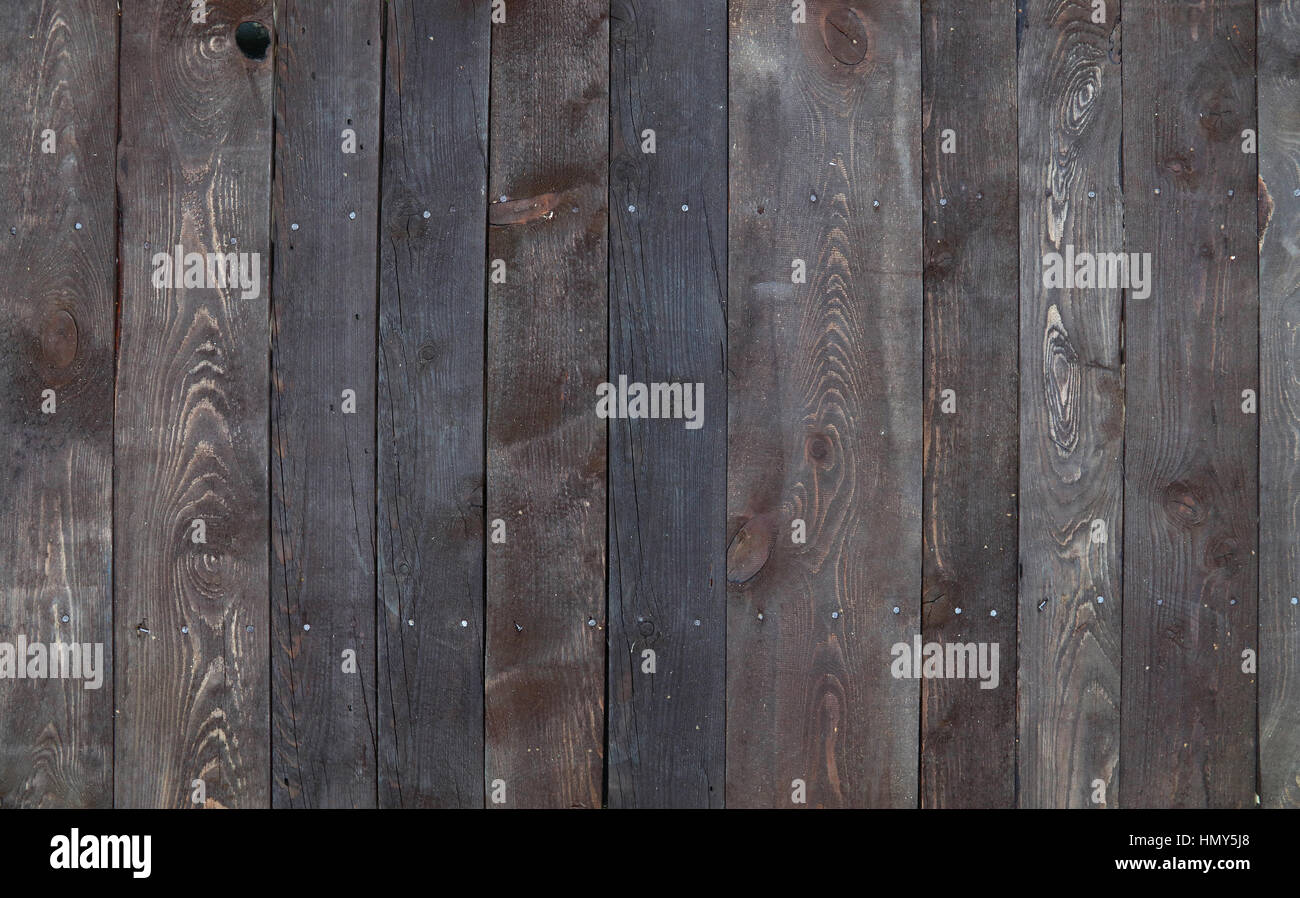 Old vintage aged grunge dark brown wooden floor planks texture background with stains, nails and noisy garbage dust Stock Photo