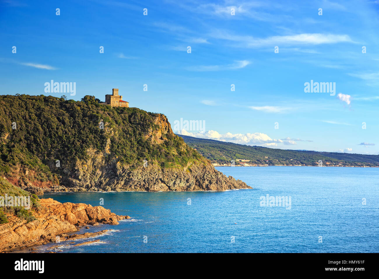 Cliff rock and building on the sea on sunset. Quercianella, Tuscany riviera, Italy, Europe. Stock Photo