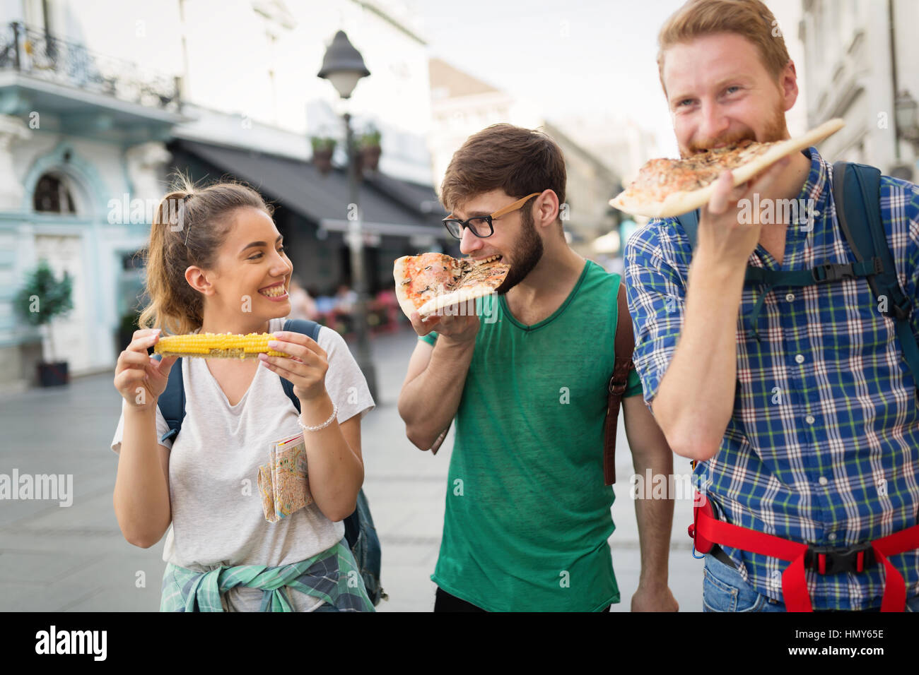 Happy group of friends eating pizza outdoors Stock Photo - Alamy