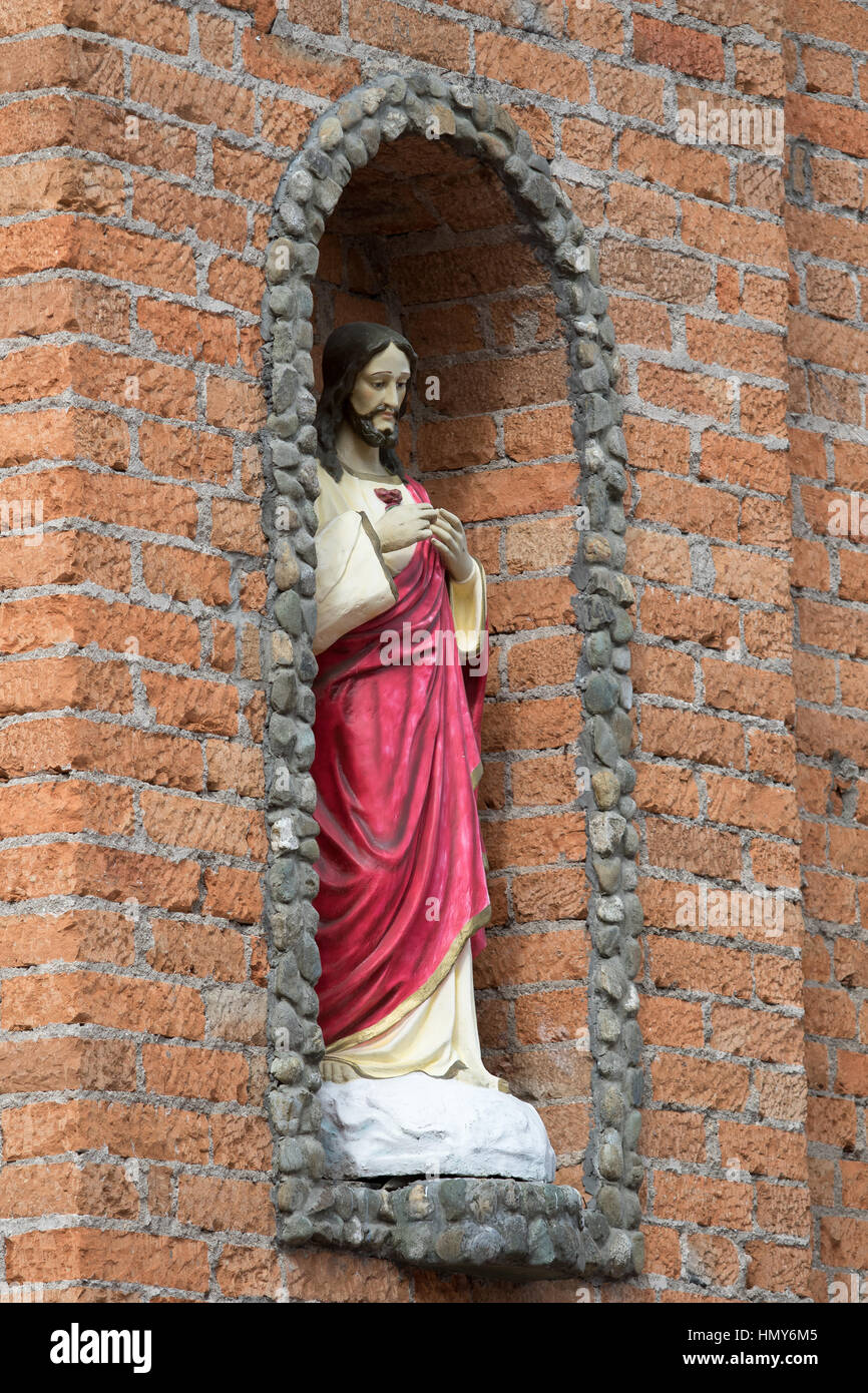 Colombia, Santa Elena, brick, church, man, outdoors, religious, statue, wall Stock Photo