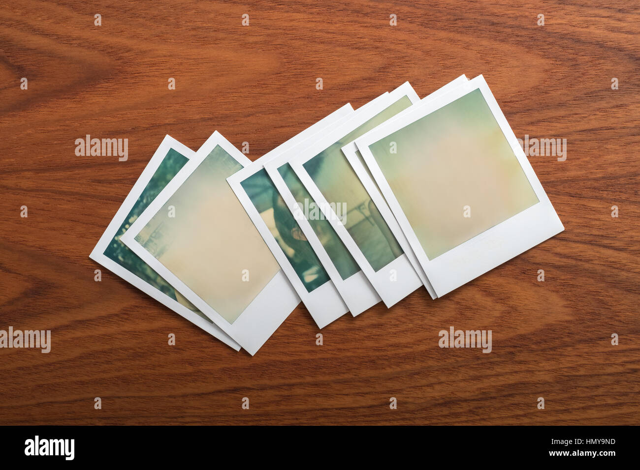 Blank instant print photographs on wooden table. Stock Photo