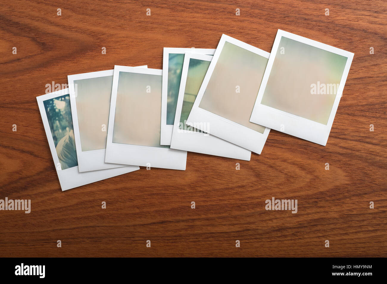 Blank instant print photographs on wooden table. Several Objects. Stock Photo