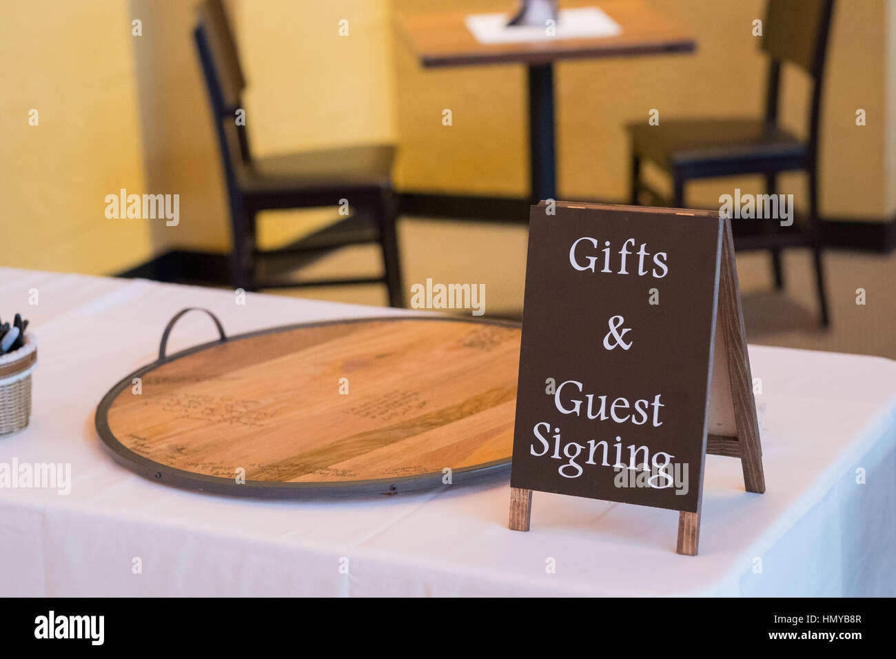 Gifts and guest book signing table sign points to the guestbook table