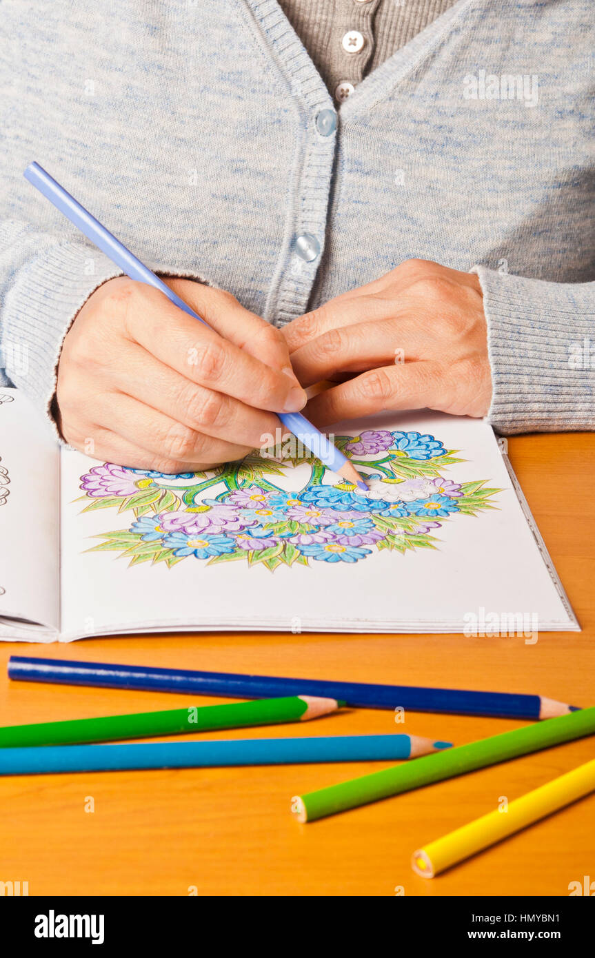 woman coloring a colouring book for adults, mindfulness concept Stock Photo