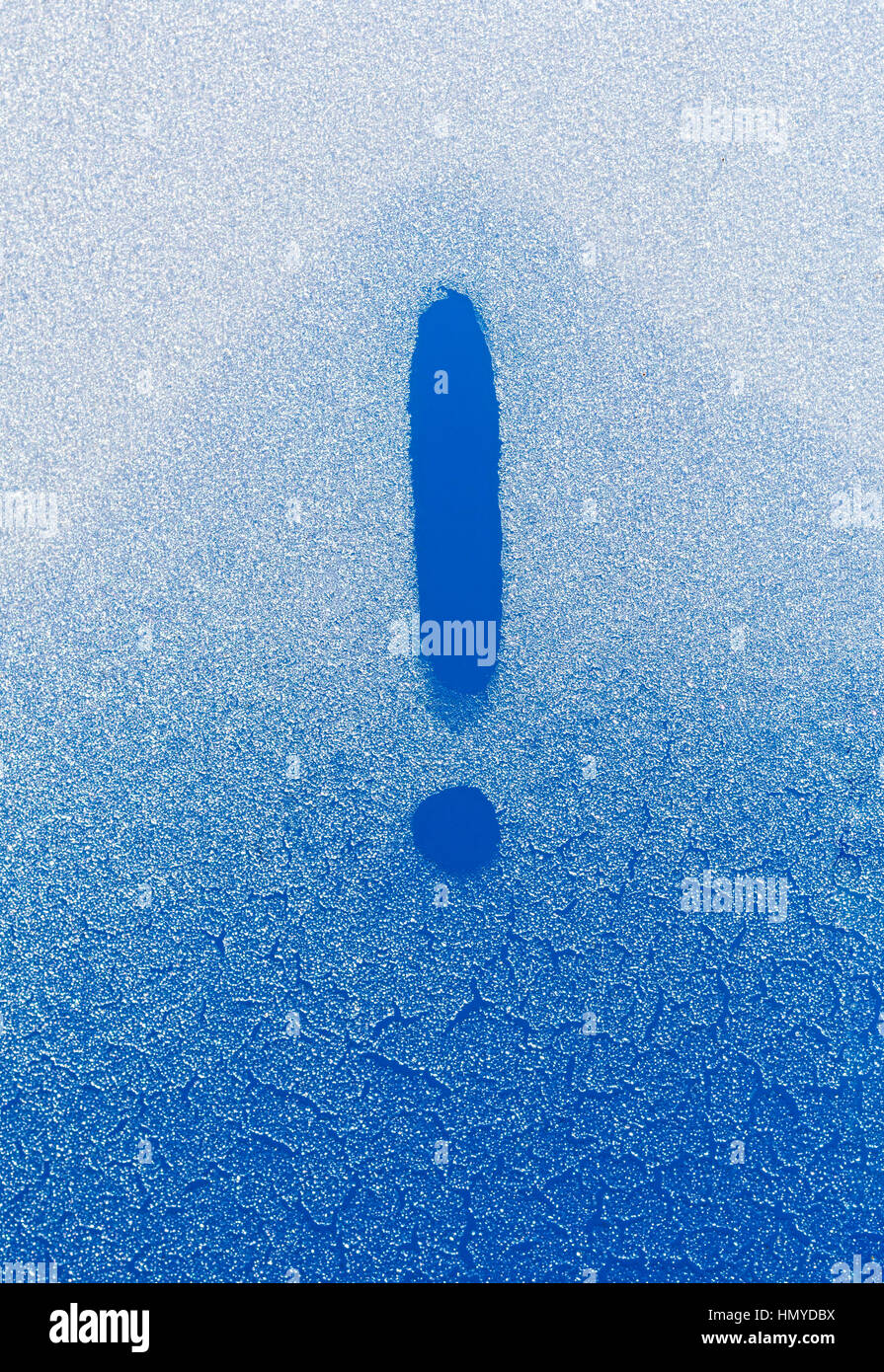 Exclamation mark written in a frozen glass against blue sky Stock Photo