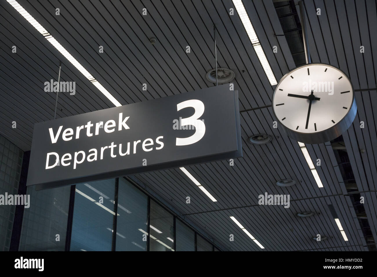 Sign to departures terminal and clock at airport Stock Photo