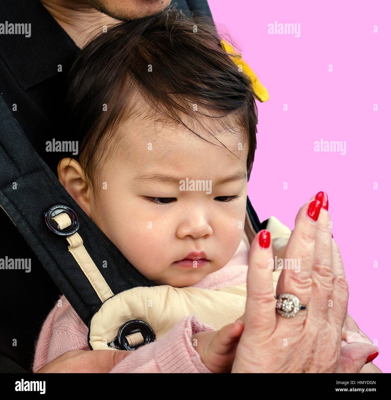 Baby touching hands with Gradma Stock Photo