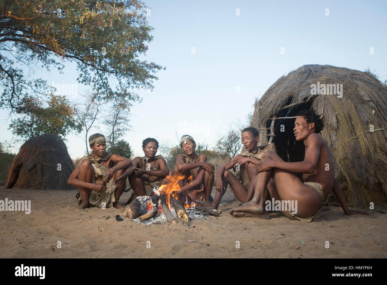 San Bushmen gather around a fire at dusk Stock Photo - Alamy