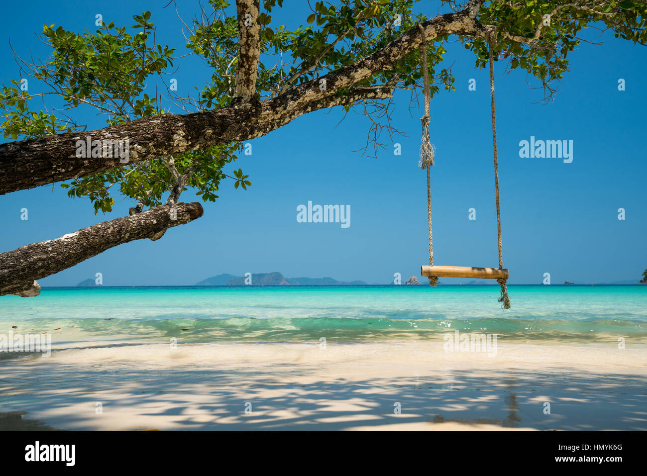 swing hang on big tree over beach sea background, Nyaung Oo Phee, Myanmar Stock Photo