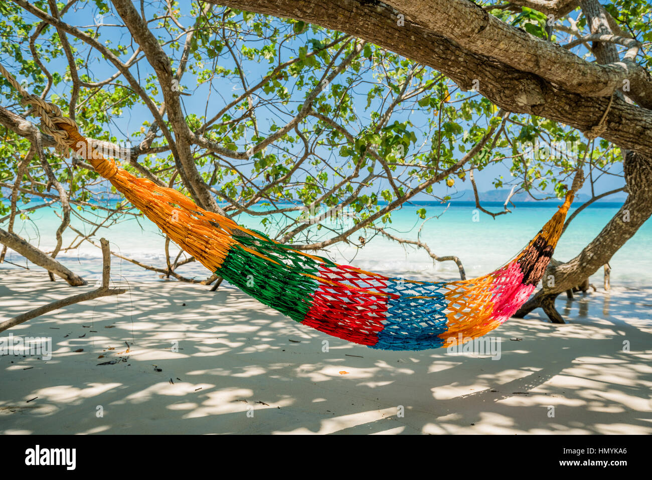 Hammock Tree Straps hang over the beach under shade, nobody on day time wide shot background at Nyaung Oo Phee, Myanma Stock Photo