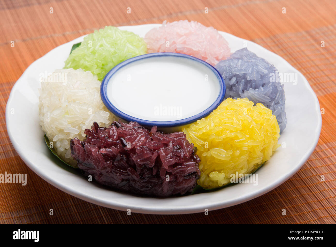 dessert sweet sticky rice with coconut milk in plate on wood pattern background Stock Photo