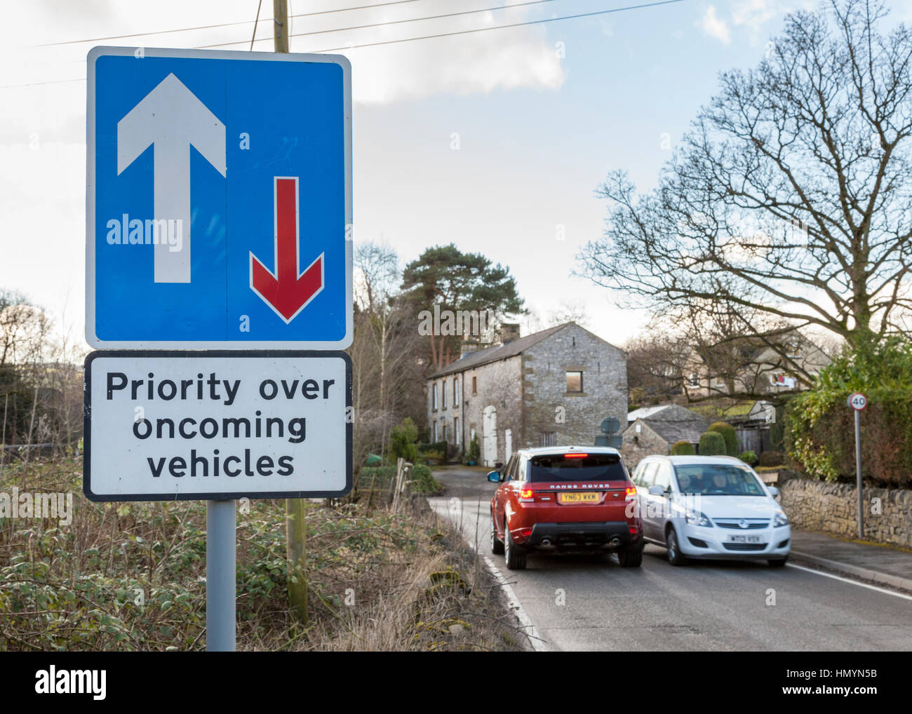 Car driver ignoring road sign giving priority over oncoming vehicles , Brough, Derbyshire. England, UK Stock Photo