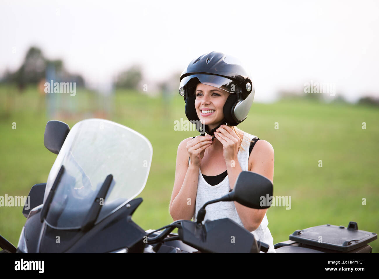 Pretty blond woman enjoying a motorbike ride in countryside Stock Photo ...