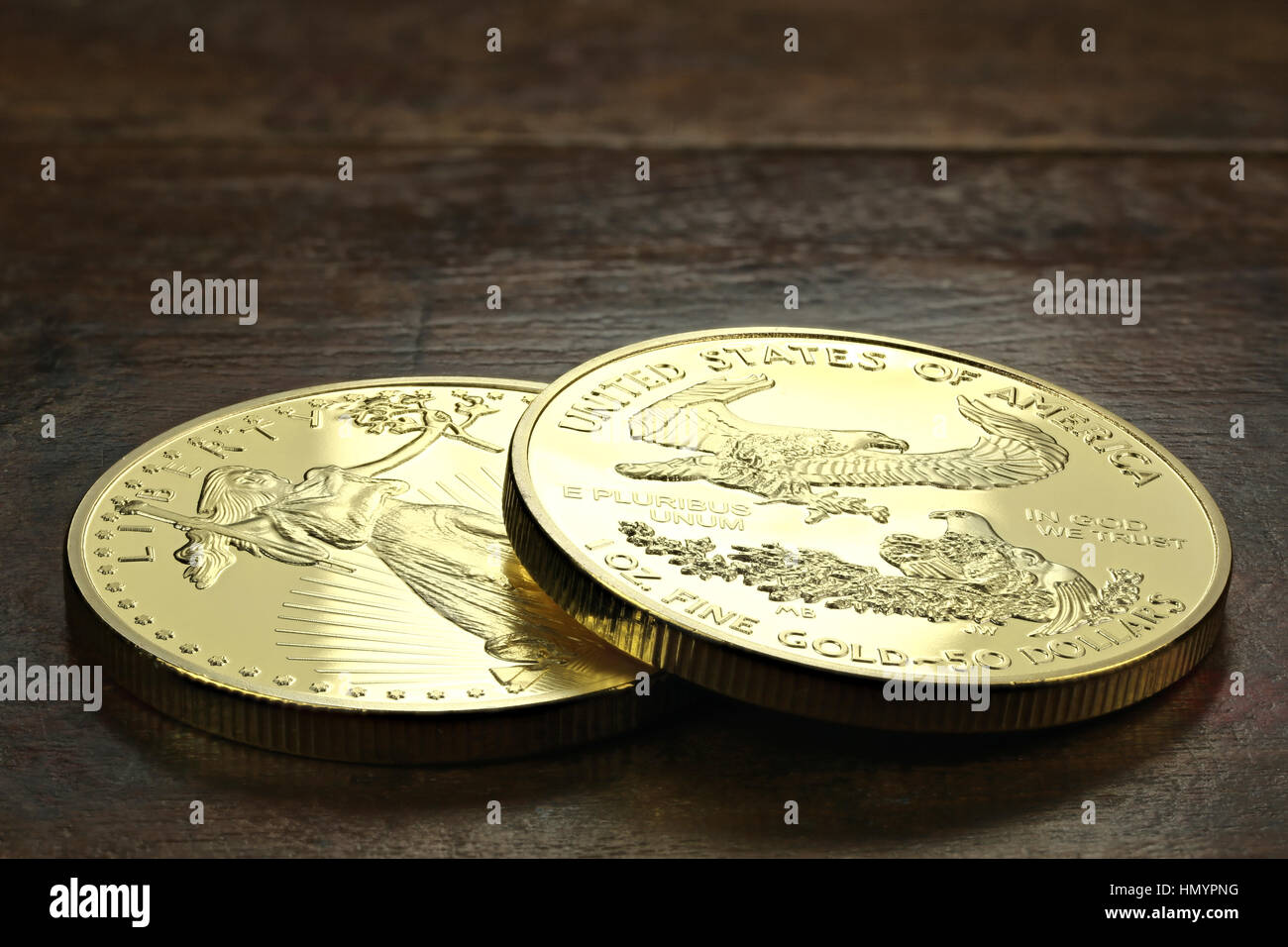 1 ounce American gold eagle bullion coins on wooden background Stock Photo