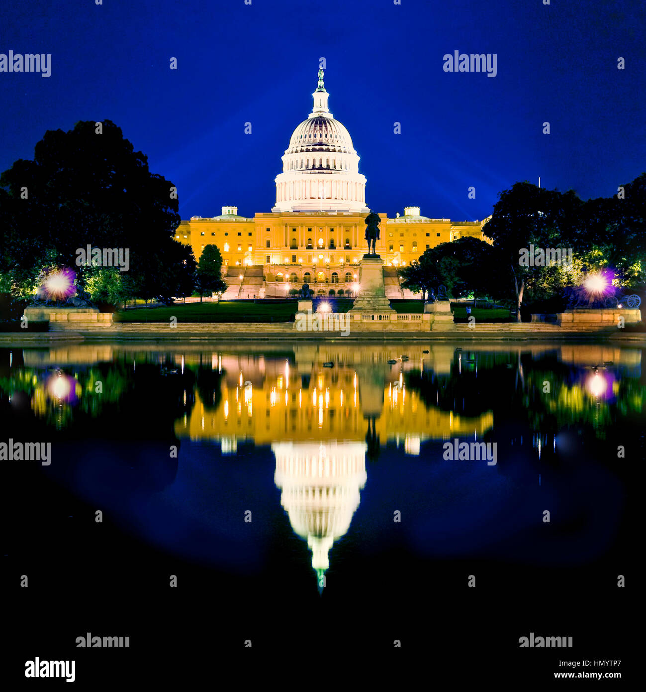 The United States Capitol Building at night with reflection in Washington DC Stock Photo