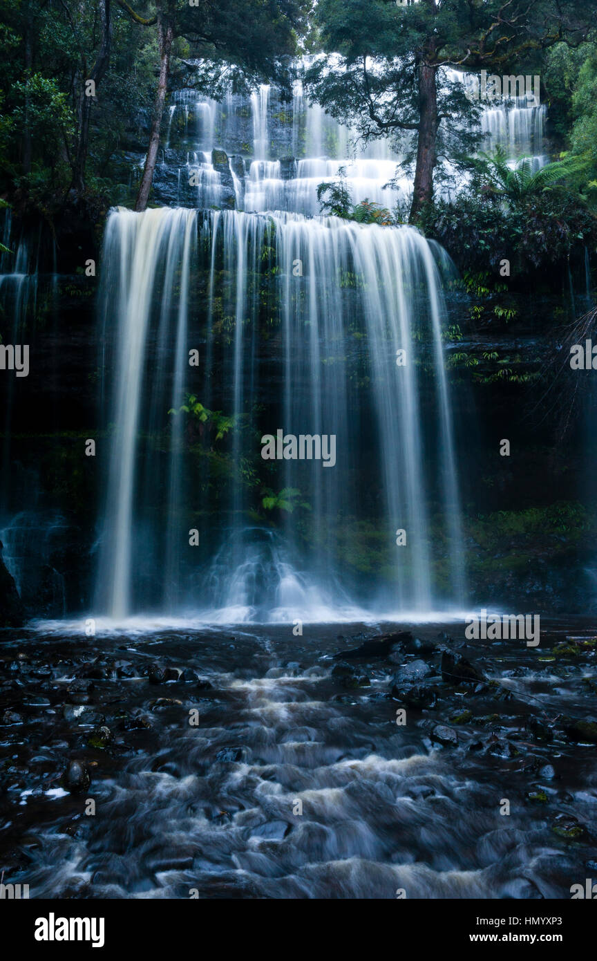 A misty curtain of water cascades down a tiered waterfall in a cool temperate rainforest. Stock Photo