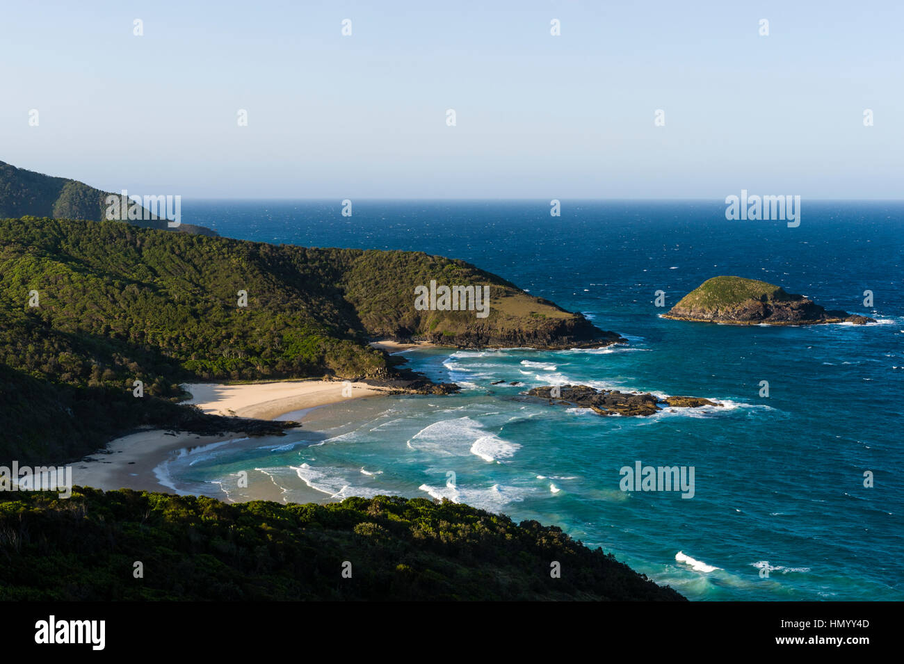 Uninhabited and pristine beaches beneath mountain forests on a rugged coastline. Stock Photo