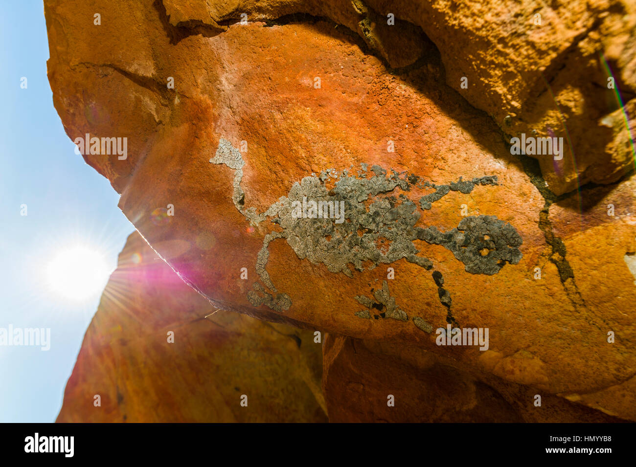 An ancient Aboriginal bees wax evil spirit on the ceiling of a sandstone cave. Stock Photo