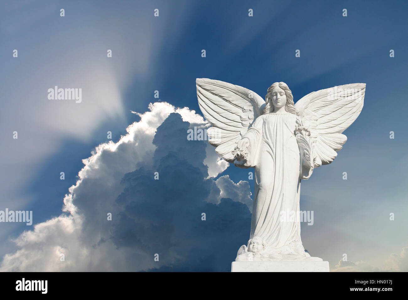 White Angel with blue sky and clouds, symbolic image for celestial, purity, hope Stock Photo
