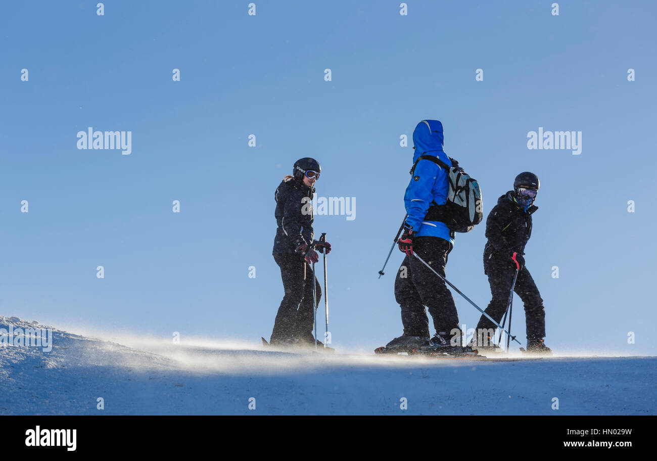 Skiers enjoy a sunny day on the ski slopes in Postavaru Mountain, Poiana Brasov, the most appreciated Romanian winter resort. Stock Photo