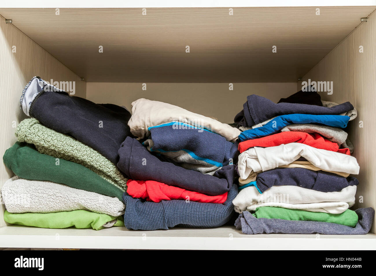 A stack of knitted warm woolen clothes in wardrobe close up Stock Photo Alamy