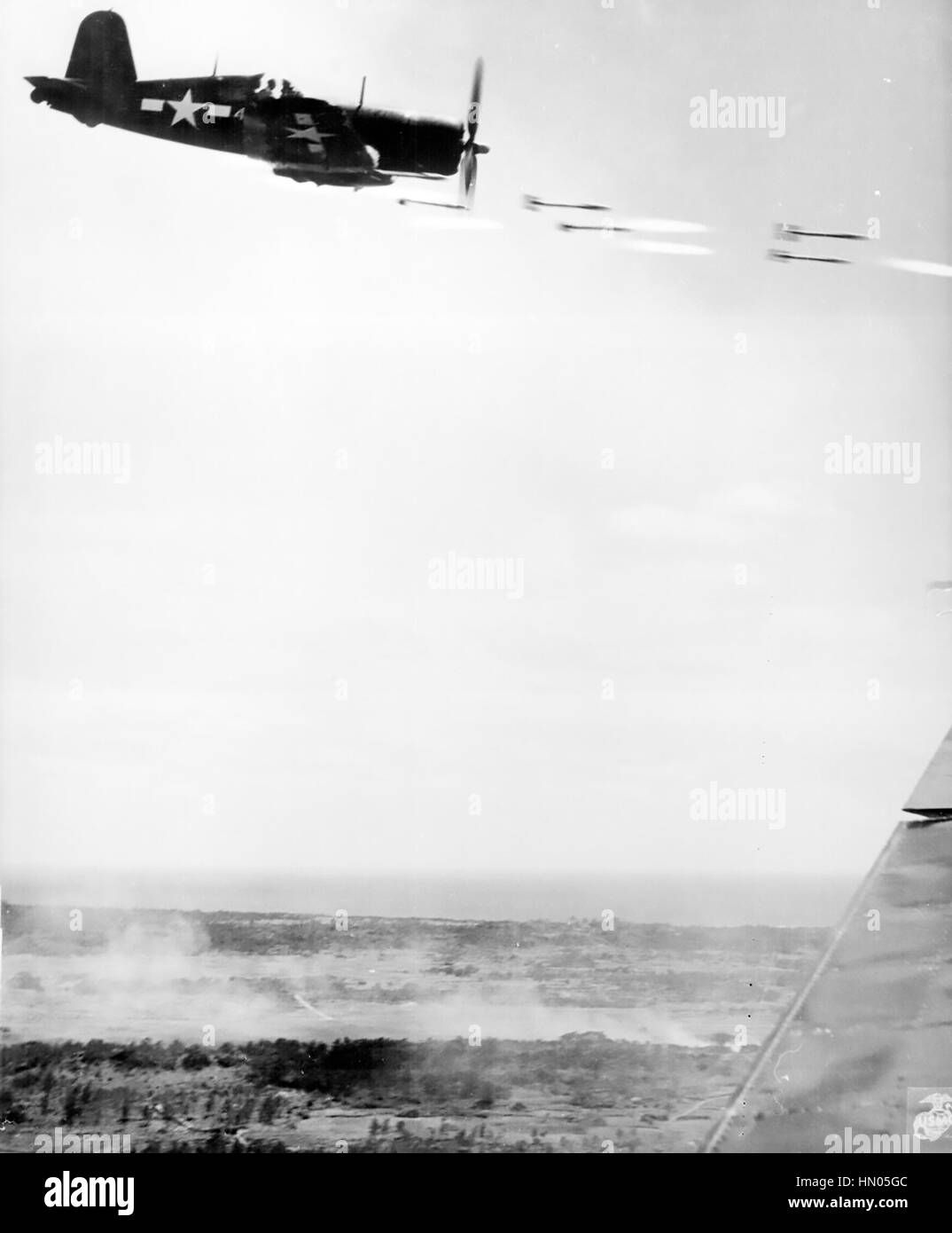 BATTLE OF OKINAWA  June 1945. A  US Marine Corsair fires its rockets against a Japanese position. Photo: Lt David D.Duncan/US Marines Stock Photo