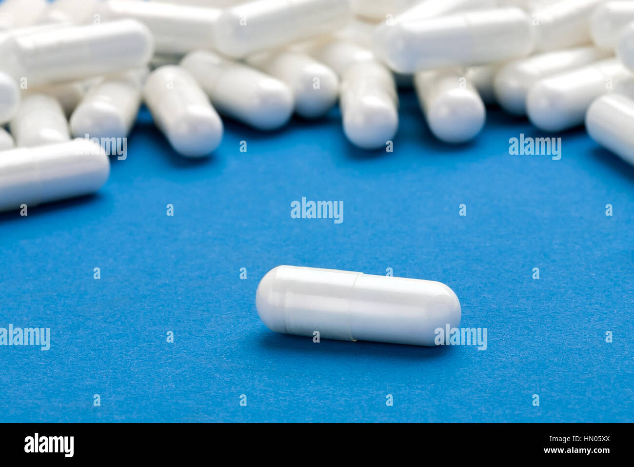 White pills on blue background. Close up. High resolution product. Health care concept Stock Photo