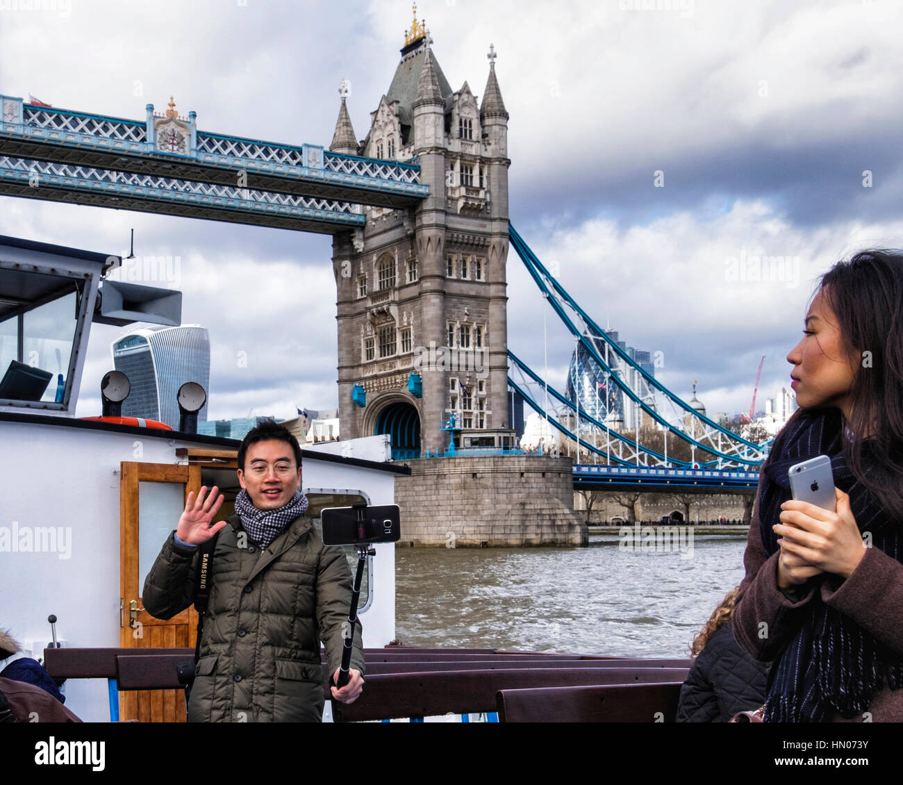 London, UK. Tourist takes selfie with Tower Bridge using mobile phone