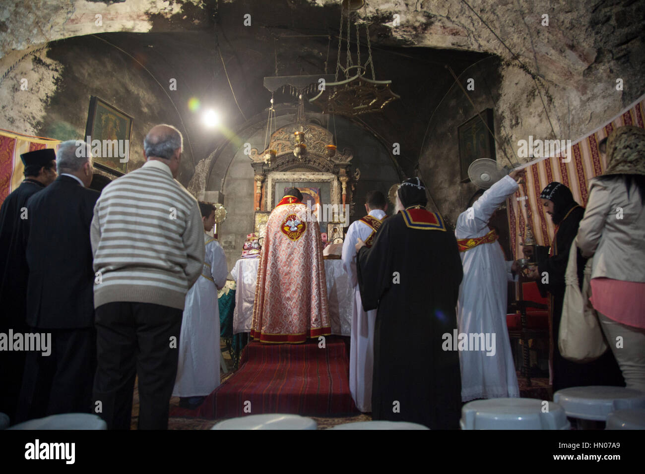 Jerusalem, Israel - November 17, 2013: Syrian Orthodox priest holds Sunday mass in the Syrian Chapel next to Saint Joseph of Eritrea tomb in the Churc Stock Photo