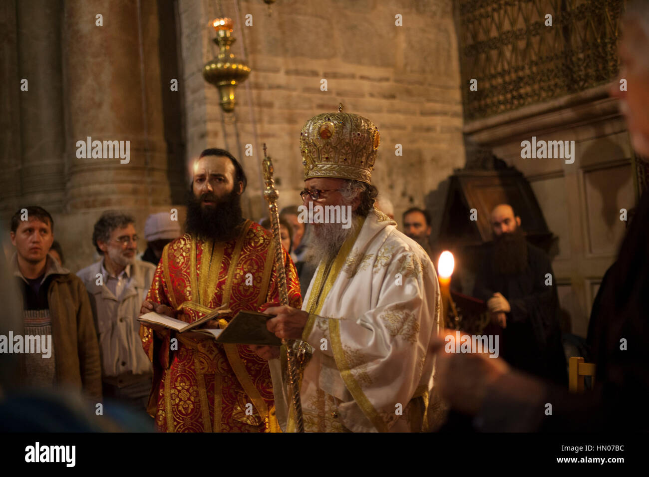 Jerusalem, Israel - July 13, 2014: Greek Orthodox priests hold mass in front of the Aedicula, place believed to be the tomb of Christ. Greek orthodox  Stock Photo