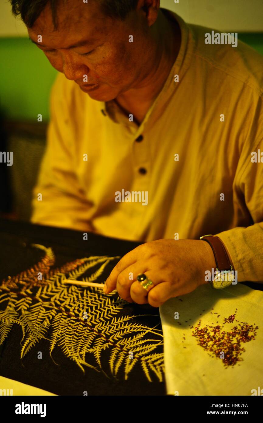 Gold-thread embroideries by master artist Tiao Nithakhong Somsanith, a descendant of Vang Na, in the line of Viceroys proceeding from the former Luang Stock Photo